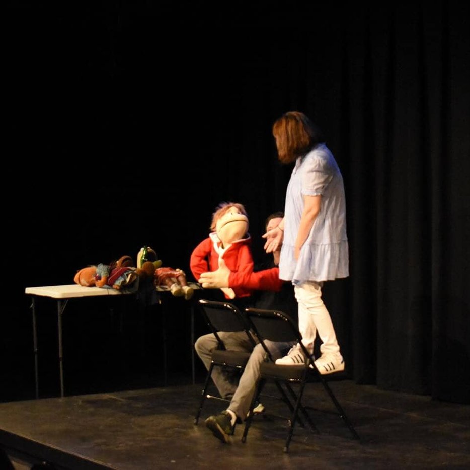 Improv actors at desk scene